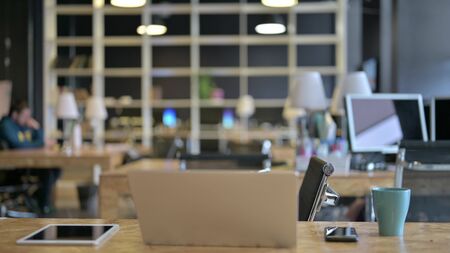 The Empty Office with Open Laptop on Deskの写真素材