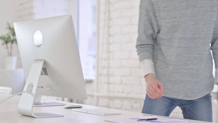 Young Latin Woman Standing up and Going away in Officeの写真素材