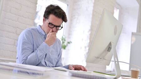 Sick Working Young Man Coughing in Modern Officeの写真素材