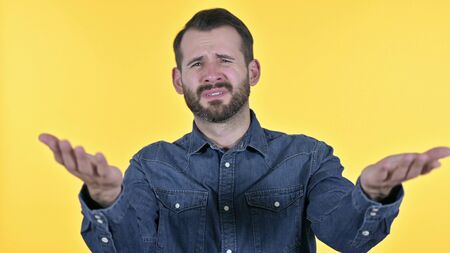 Portrait of Disappointed Young Man Reacting to Failure, Yellow Background
