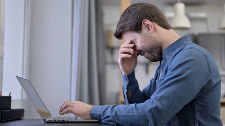 The Beard Young Man having Headache on Laptop