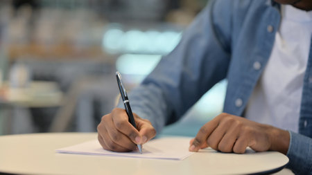African Man Writing on Paper, Close Up