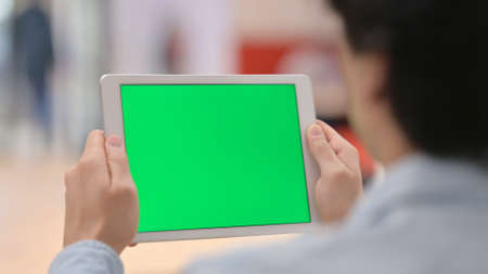 Man Watching Tablet with Green Chroma Key Screen