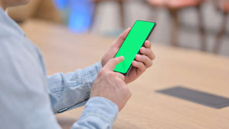 Man using Smartphone with Green Chroma Key Screenの写真素材