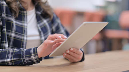 Close up of Female Using Tablet for Browsing Internetの写真素材