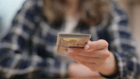 Female Hands Giving Away Dollars, Close upの写真素材