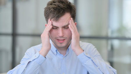 Portrait of Young Man having Headache