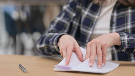 Female Hands Putting Letter in Envelop an Giving, Close upの写真素材