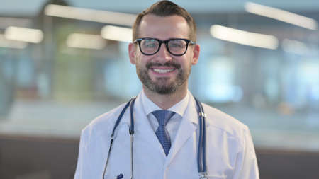 Portrait of Young Male Doctor Smiling at Cameraの写真素材