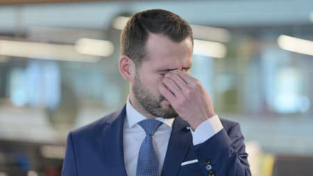 Frustrated Middle Aged Businessman Upset by Conditions, Feeling Tiredの写真素材