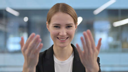 Portrait of Businesswoman Pointing at the Camera and Invitingの写真素材