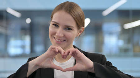 Portrait of Woman showing Heart Shape by Handsの写真素材