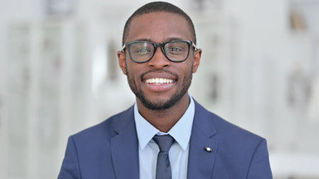 Portrait of Cheerful African Businessman doing Video Callの写真素材