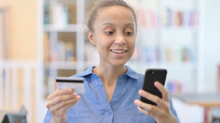 Online Payment on Smartphone by African Woman