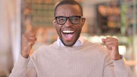 Portrait of Excited African Man Celebrating Successの写真素材