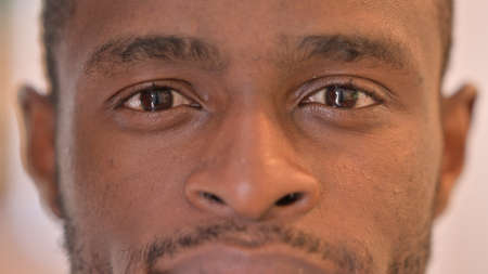 Close up of Blinking Eyes of African Manの写真素材