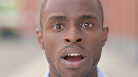 Close Up of Shocked African Man Wondering in Aweの写真素材
