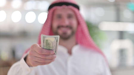 Arab Businessman Offering Dollars, Financial Investmentの写真素材