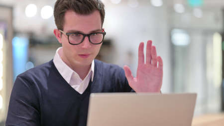 Young Businessman doing Video Call on Laptopの写真素材