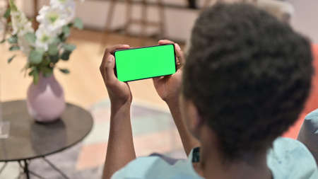 African Man Watching Smartphone with Chroma Screen