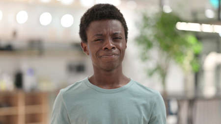 Portrait of Young African Man saying No by Head Shakeの写真素材
