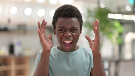 Portrait of Furious Young African Man Screaming, Shoutingの写真素材