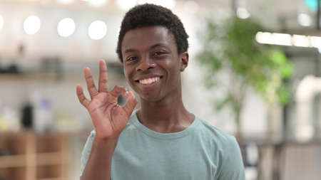 Portrait of Young African Man showing OK Signの写真素材