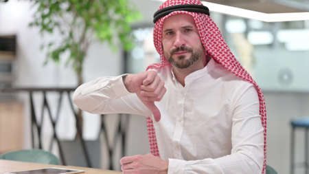 Disappointed Arab Businessman doing Thumbs Downの写真素材