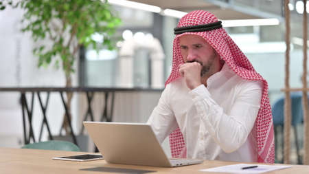 Sick Arab Businessman with Laptop Coughingの写真素材
