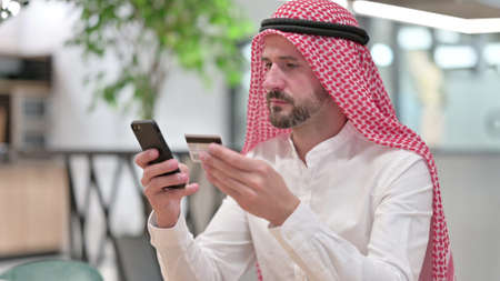 Online Payment on Smartphone by Arab Manの写真素材