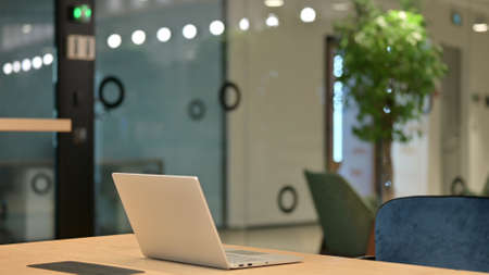 Empty Office Space with Open Laptop on Desk