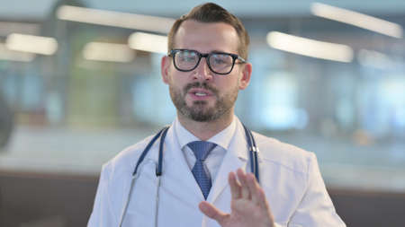 Portrait of Online Video Call by Young Male Doctorの写真素材