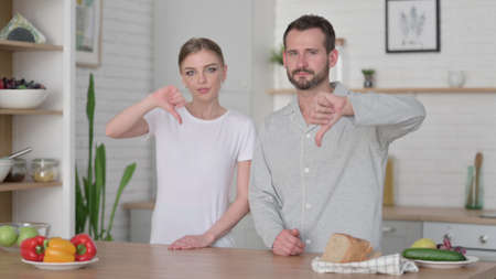 Woman and Man Showing Thumbs Down Signの写真素材