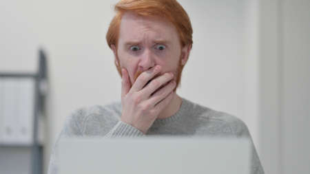 Beard Redhead Man having Loss while using Laptop