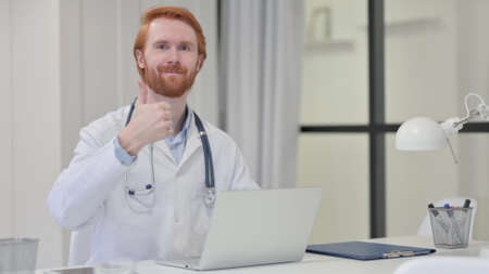 Redhead Male Doctor with Thumbs Up Signの写真素材