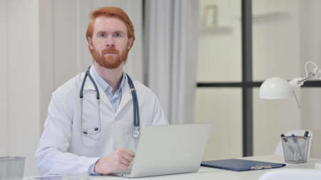 Redhead Male Doctor Looking at Cameraの写真素材