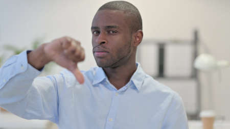 Portrait of African Man Doing Thumbs Down in Office