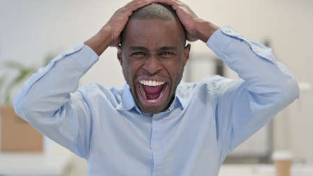 Portrait of African Man Shouting, Screaming in Office