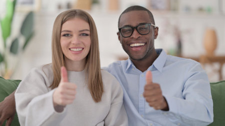 Positive Interracial Couple showing Thumbs Up, Home
