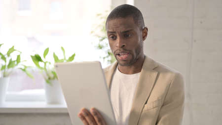 Portrait of Video Call on Tablet by African Man in Office