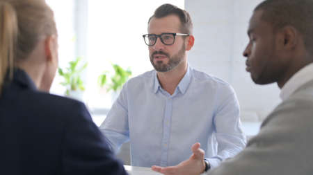 Businessman Shouting to Mixed Race Business People
