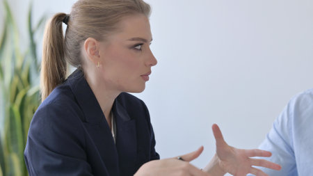 Close up of Young Businesswoman Talking to Colleagues