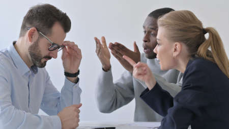 Business People Scolding Businessman in Officeの写真素材