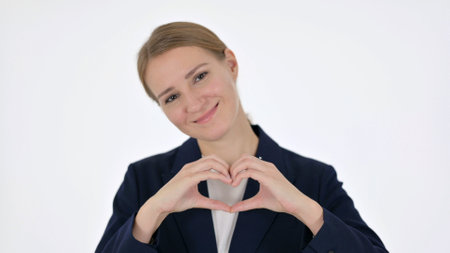 Young Businesswoman showing Heart Shape by Hands on White Backgroundの写真素材