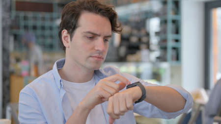 Portrait of Man using Smart watchの写真素材