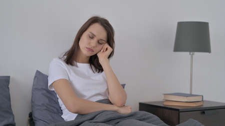 Woman Taking Nap while Sitting in Bed