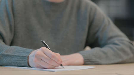 Close up of Hands of Man Writing on Paperの写真素材