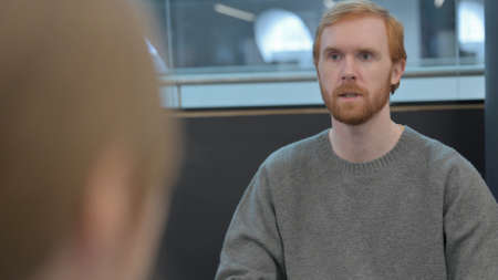 Rear View of Young Man having Conversation with Woman
