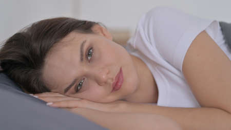 Woman Awake in Bed Thinking