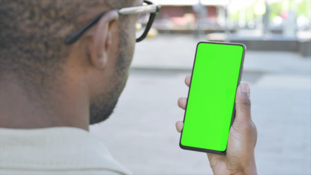 Close Up of African Man Using Green Screen Smartphone Outdoor